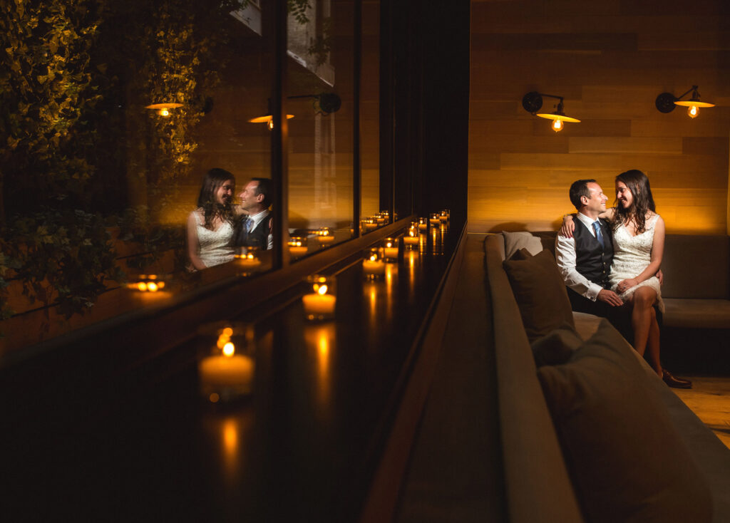 Couple in a warmly lit venue lined with candles